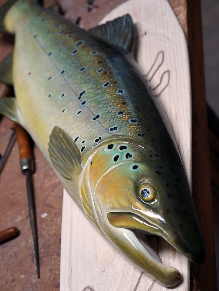 A close-up shot of a wooden fish carving
